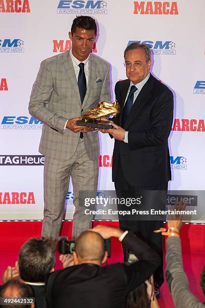 Real Madrid football president Florentino Perez presents Real Madrid football player Cristiano Ronaldo with his fourth Golden Boot Award as highest...