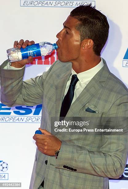 Real Madrid football player Cristiano Ronaldo takes a sip of water as he attends an award ceremony where he was presented with his fourth Golden Boot...