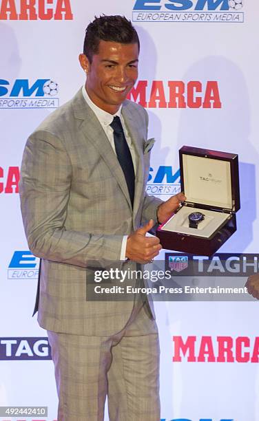 Real Madrid football player Cristiano Ronaldo is given a watch as he attends an award ceremony where he was presented with his fourth Golden Boot...