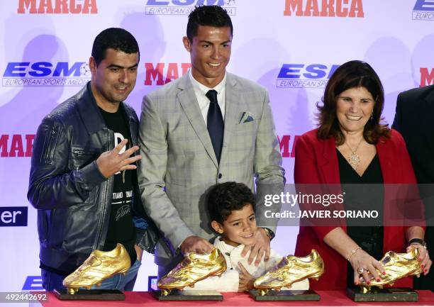 Real Madrid's Portuguese forward Cristiano Ronaldo poses with his mother Dolores Aveiro , his son Cristiano Ronaldo Jr and his brother Hugo after...