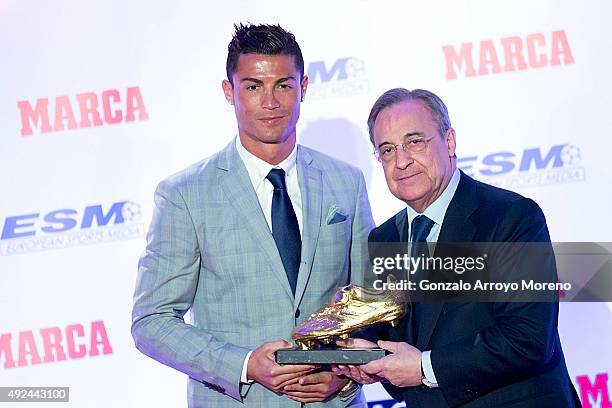 Real Madrid football player Cristiano Ronaldo receives from hands of Real Madrid president Florentino Perez his fourth Golden Boot Award as maximun...