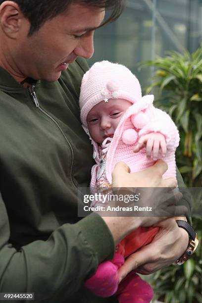Lucas Cordalis poses with newborn daughter Sophia on October 13, 2015 in Cologne, Germany. It was first public appearance of the couple Daniela...