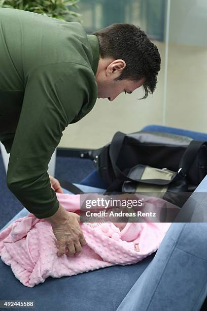 Lucas Cordalis takes care of newborn daughter Sophia on October 13, 2015 in Cologne, Germany. It was first public appearance of the couple Daniela...