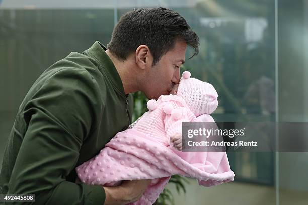 Lucas Cordalis kisses newborn daughter Sophia on October 13, 2015 in Cologne, Germany. It was first public appearance of the couple Daniela...