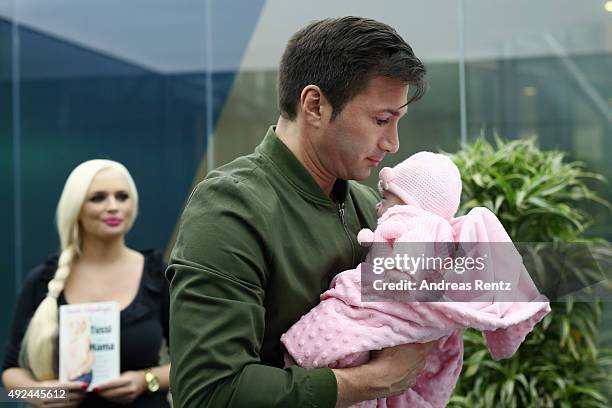 Lucas Cordalis holds newborn daughter Sophia on October 13, 2015 in Cologne, Germany. It was first public appearance of the couple Daniela...