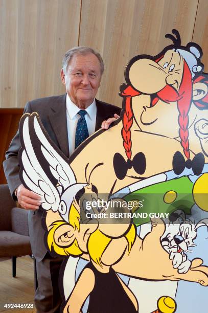 French cartoonist and author Albert Uderzo poses next to a cardboard cut-out of Asterix and Obelix characters during a press conference in Paris on...