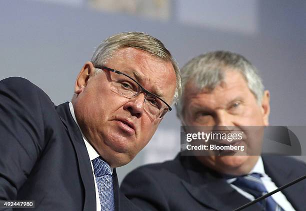 Andrey Kostin, chief executive officer of VTB Bank PJSC, left, and Igor Sechin, chief executive officer of Rosneft OJSC, speak while attending a...