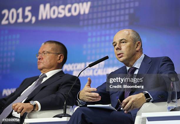 Anton Siluanov, Russia's finance minister, right, speaks as Alexey Ulyukaev, Russia's economy minister, looks on during a panel session on the...