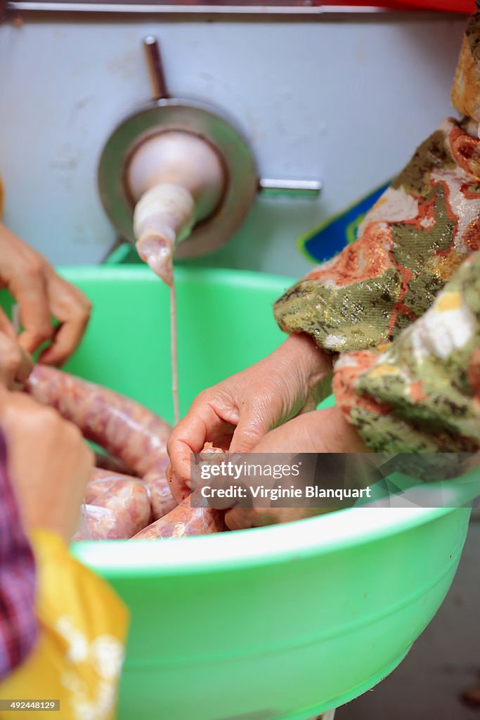 Women preparing sausages