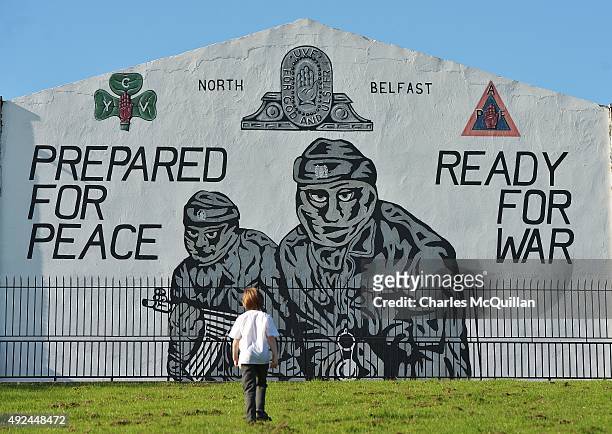 Young boy walks past a loyalist paramilitary mural on the day that the new Loyalist Community Council was launched at the Park Avenue Hotel on...