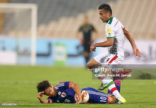 Omid Ebrahimi and Kagawa Shinji in action during the international friendly match between Iran and Japan at Azadi Stadium on October 13, 2015 in...