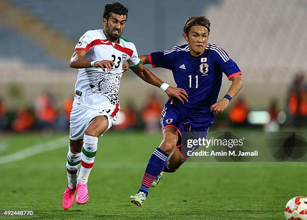 Ramin rezaeian and Usami Takashi in action during the international friendly match between Iran and Japan at Azadi Stadium on October 13, 2015 in...