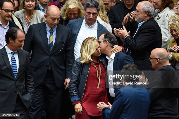 Catalonia's former Vice-President Joana Ortega is comforted by Convergencia Democratica de Catalunya spokesman Jordi Turull as she leaves Catalonia...