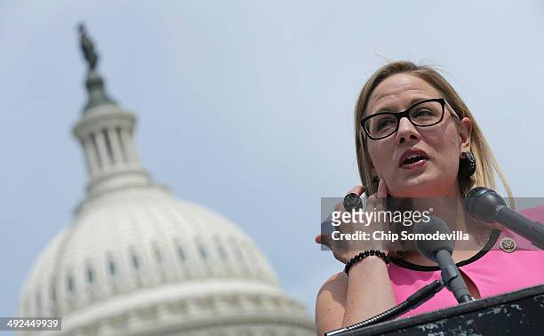 Rep. Kyrsten Sinema joins a group of bipartisan Congressmen during a news conference outside the U.S. Capitol May 20, 2014 in Washington, DC. The...