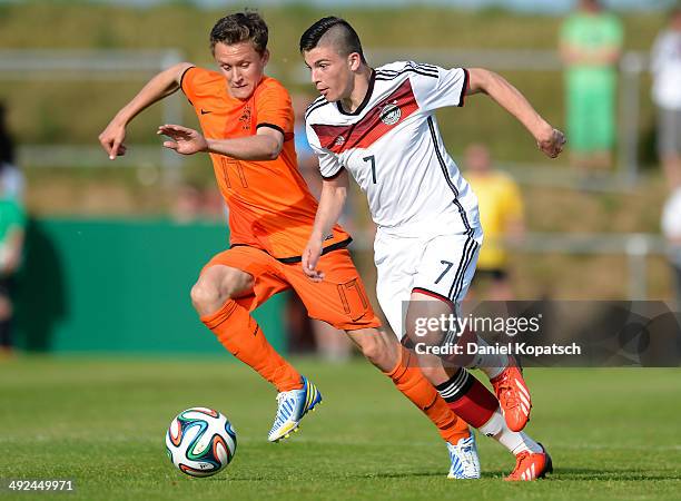 Nikos Zografakis of Germany is challenged by Martijn Kaars of the Netherlands during the international friendly U15 match between Germany and...