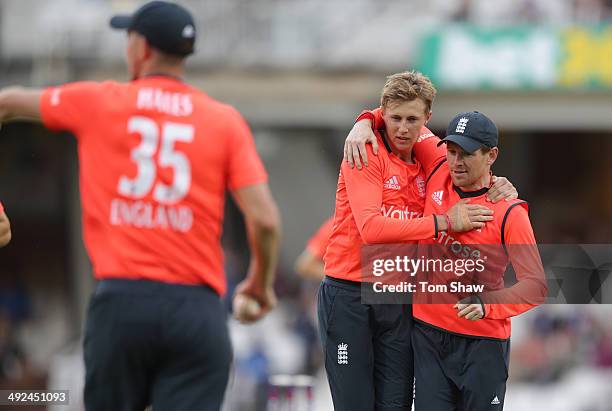 Joe Root of England is congratulated by Eoin Morgan of England after taking the wicket of Dinesh Chandimal of Sri Lanka during NatWest T20...