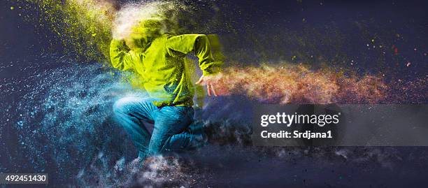 unrecognizable hip-hop male dancer with hoodie jumping - hiphop stockfoto's en -beelden