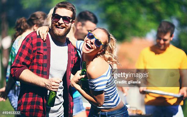 friends having barbecue party. - grill friends and beer stock pictures, royalty-free photos & images