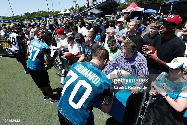 Luke Bowanko of the Jacksonville Jaguars signs autographs for fans after rookie minicamp at Everbank Field on May 16, 2014 in Jacksonville, Florida.