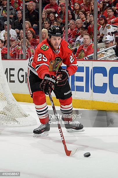 Bryan Bickell of the Chicago Blackhawks reaches for the puck in Game Five of the Second Round of the 2014 Stanley Cup Playoffs against the Minnesota...
