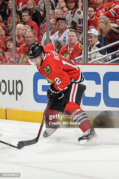 Peter Regin of the Chicago Blackhawks grabs the puck in Game Five of the Second Round of the 2014 Stanley Cup Playoffs against the Minnesota Wild at...