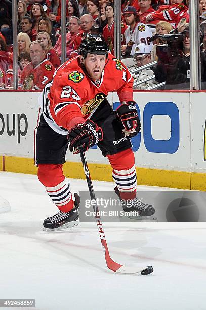 Bryan Bickell of the Chicago Blackhawks reaches for the puck in Game Five of the Second Round of the 2014 Stanley Cup Playoffs against the Minnesota...