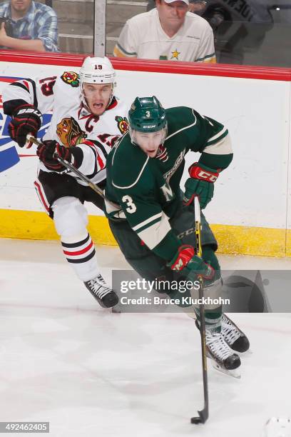 Charlie Coyle of the Minnesota Wild skates with the puck while Jonathan Toews of the Chicago Blackhawks defends during Game Six of the Second Round...