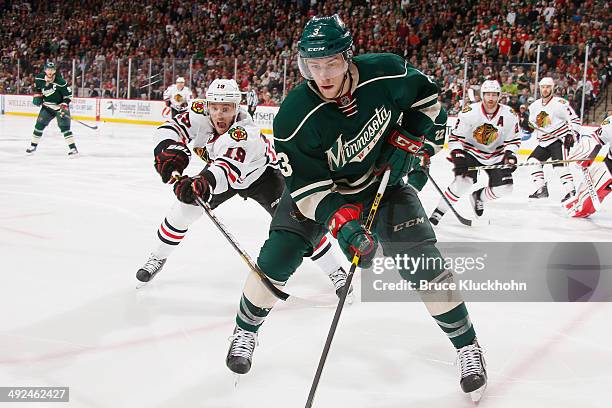 Charlie Coyle of the Minnesota Wild controls the puck with Jonathan Toews of the Chicago Blackhawks defending during Game Six of the Second Round of...