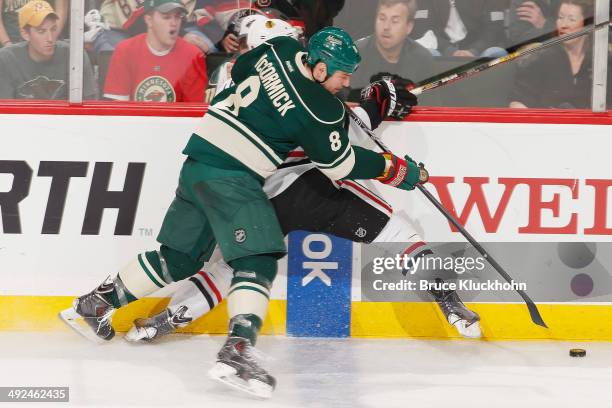 Cody McCormick of the Minnesota Wild checks Nick Leddy of the Chicago Blackhawks during Game Six of the Second Round of the 2014 Stanley Cup Playoffs...