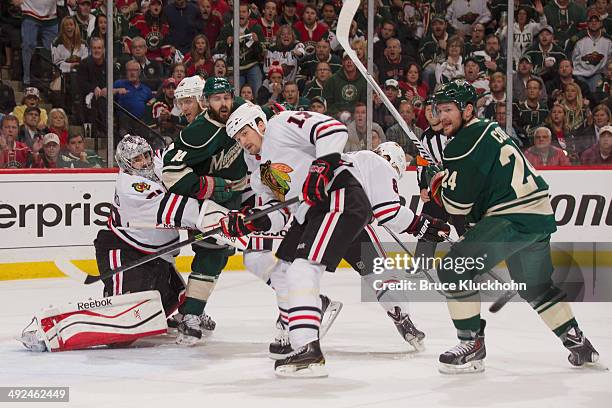 Corey Crawford, Peter Regin, Sheldon Brookbank, and Nick Leddy of the Chicago Blackhawks defend their goal against Justin Fontaine and Matt Cooke of...
