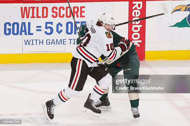 Patrick Sharp of the Chicago Blackhawks skates past a Minnesota Wild defender on his way to the puck during Game Six of the Second Round of the 2014...