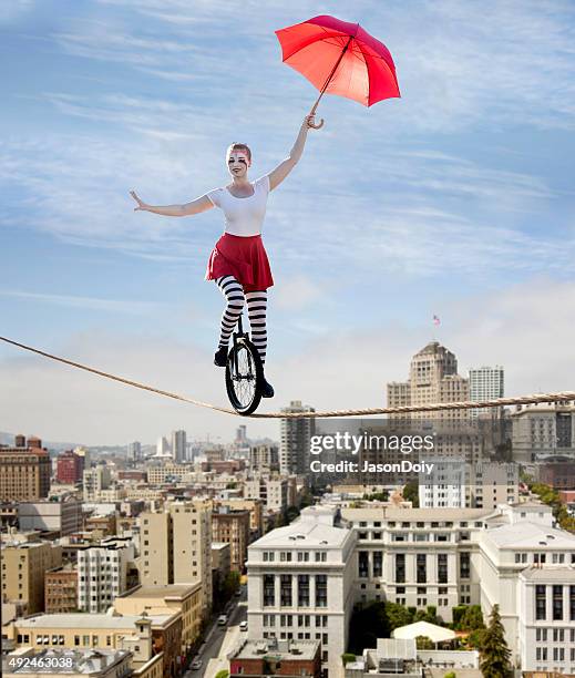 circus tightrope walker on a unicycle - balancing act stockfoto's en -beelden