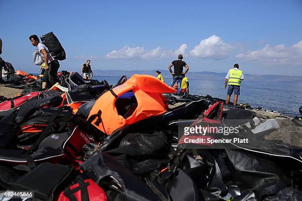 Discarded life preservers are scattered along a beach following the arrival of rafts carrying Syrian and Iraqi refugees on the island of Lesbos on...