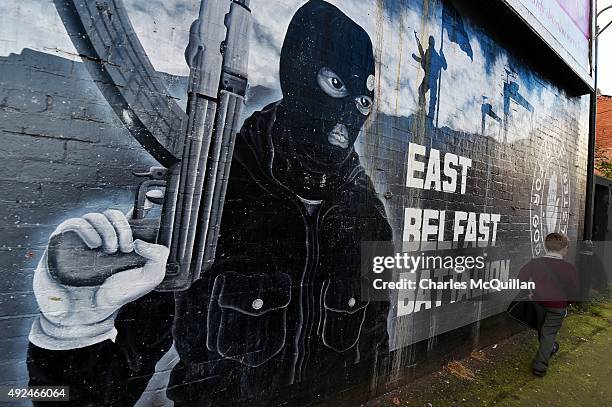 Young boy walks past a loyalist paramilitary mural on the day that the new Loyalist Community Council was launched at the Park Avenue Hotel on...