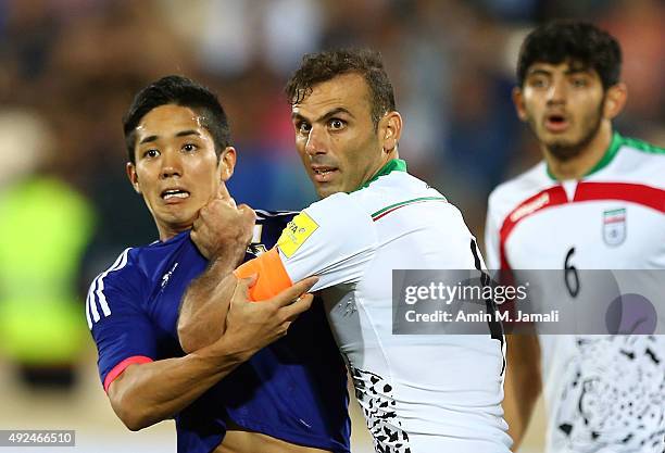 Muto Yoshinori and Seyed Jalal Hosseini in Action during the international friendly match between Iran and Japan at Azadi Stadium on October 13, 2015...