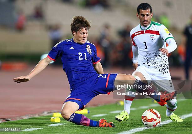 Ehsan Hajsafi and Sakai Gotoku in action during the international friendly match between Iran and Japan at Azadi Stadium on October 13, 2015 in...