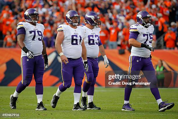 Offensive guard Michael Harris, center Joe Berger, guard Brandon Fusco and tackle Matt Kalil of the Minnesota Vikings head for the bench as they face...