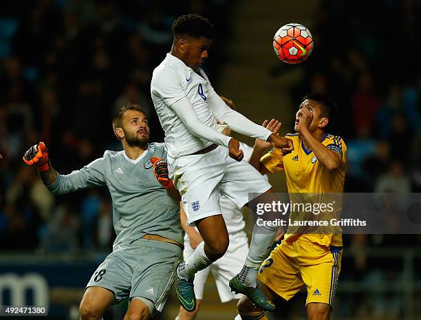 Chuba Akpom of England heads toward goal under pressure from Stanislav Pavlov of Kazakhstan during the European Under 21 Qualifier between England...