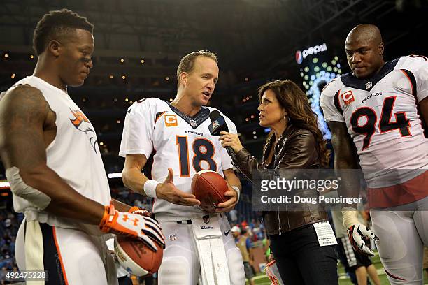 Sports sideline reporter Michele Tafoya interviews quarterback Peyton Manning of the Denver Broncos along with wide receiver Demaryius Thomas and...