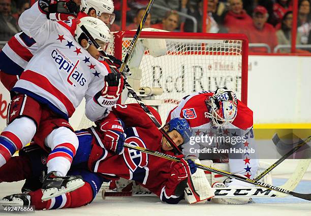 Drayson Bowman of the Montreal Canadiens gets thrown to the ice by Jack Hillen of the Washington Capitals during the game at Verizon Center on...