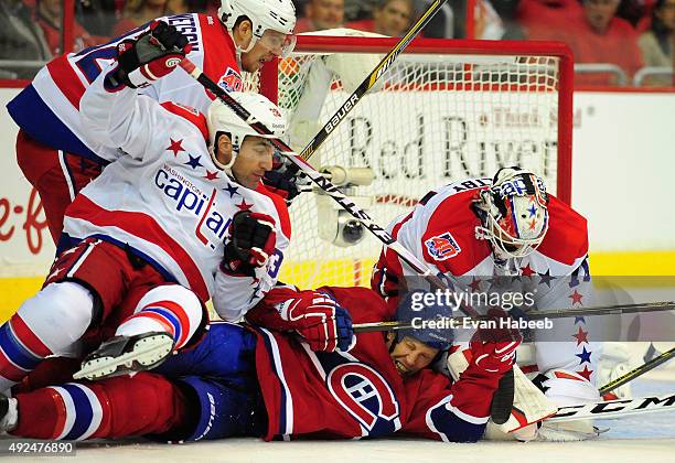 Drayson Bowman of the Montreal Canadiens gets thrown to the ice by Jack Hillen of the Washington Capitals during the game at Verizon Center on...