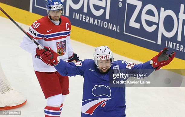 Julien Desrosiers of France celebrate his goal as captain Tomas Rolinek of Czech Republic looks on during the 2014 IIHF World Championship between...