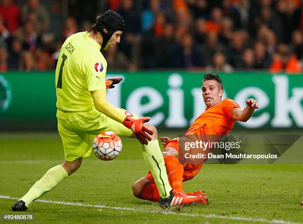 Robin van Persie of the Netherlands beats goalkeeper Petr Cech of the Czech Republic as scores their second goal and his 50th in international...