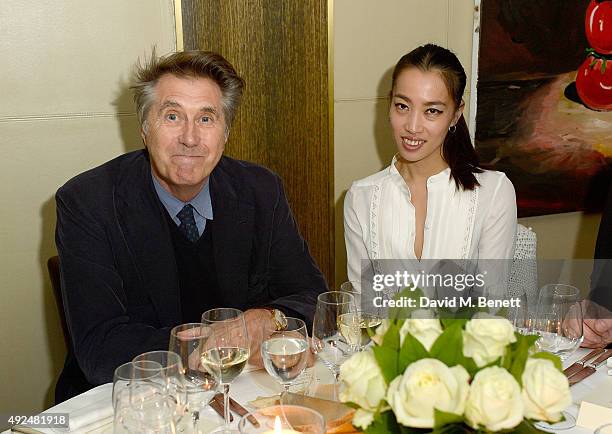 Bryan Ferry and Yi Zhou attend the Deconstructed Project with a private dinner hosted by Caroline Issa, David Shrigley and Massimo Nicosia on October...