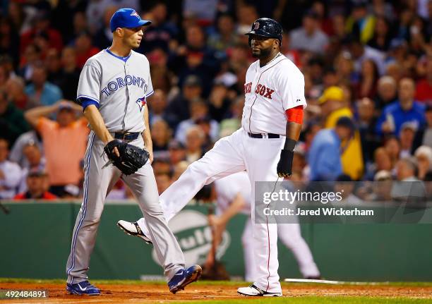 David Ortiz of the Boston Red Sox reacts following a bases-loaded double play to end the fourth inning in front of J.A. Happ of the Toronto Blue Jays...