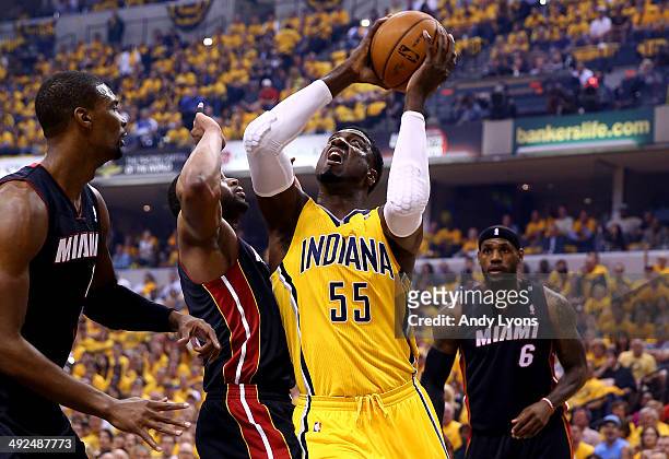 Roy Hibbert of the Indiana Pacers goes to the basket as Dwyane Wade and Chris Bosh of the Miami Heat defend during Game Two of the Eastern Conference...