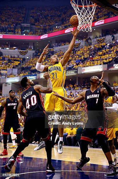 David West of the Indiana Pacers goes up for a basket as Udonis Haslem and Chris Bosh of the Miami Heat defend during Game Two of the Eastern...