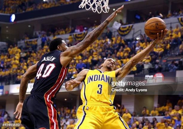George Hill of the Indiana Pacers goes to the basket as Udonis Haslem of the Miami Heat defends during Game Two of the Eastern Conference Finals of...