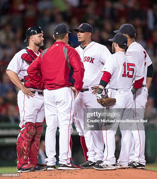 Felix Doubront of the Boston Red Sox talks with pitching coach Juan Nieves before being pulled from the game against the Toronto Blue Jays in the...