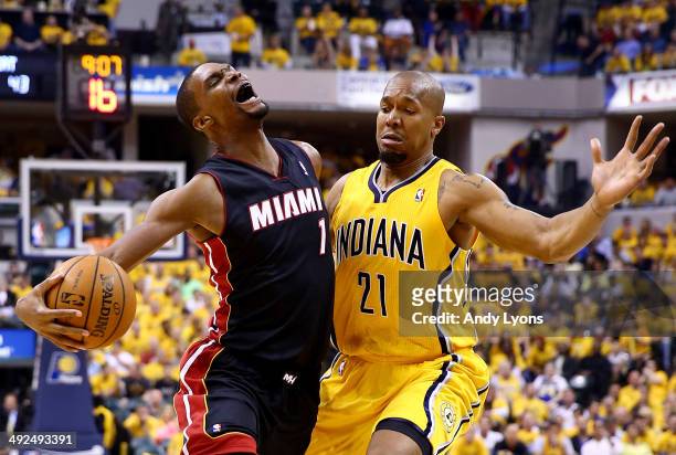 Chris Bosh of the Miami Heat goes to the basket as David West of the Indiana Pacers defends during Game Two of the Eastern Conference Finals of the...